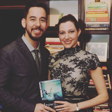 Anna Hillinger and Mike Shinoda holding her book.